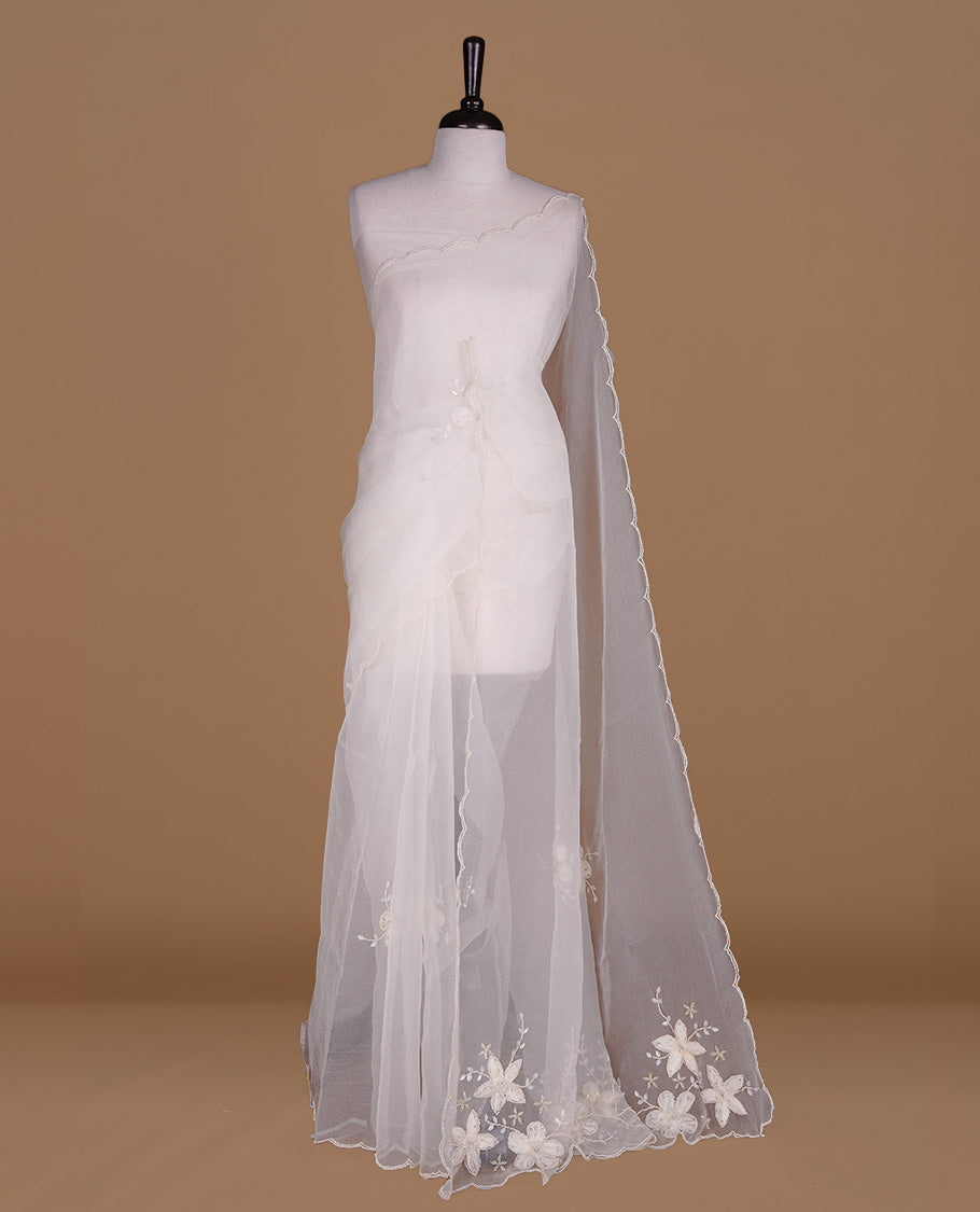 White colour crush organza saree featuring white floral work with beats & sequins, highlighting scalp with beats worked border, paired with matching blouse piece.