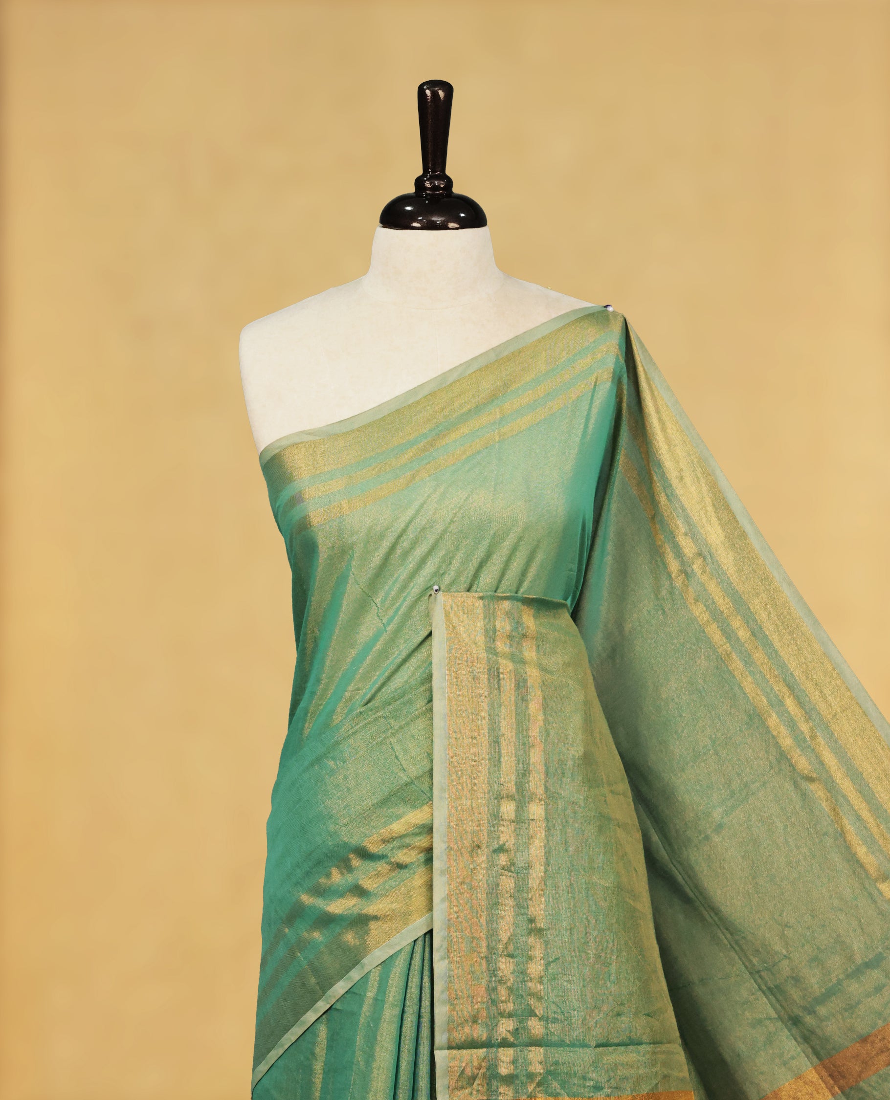 Aqua colour Semi Tissue Silk saree featuring Elegant plain body, Enhanced with Gold tissue Border & Striped Pallu & beautiful Tassels for Elegant Prefect Look.