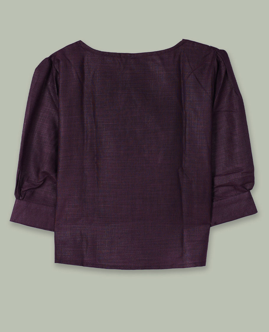 Deep plum three-quarter sleeve top with round neckline and tonal crochet floral appliqués placed at the center front and near the hem