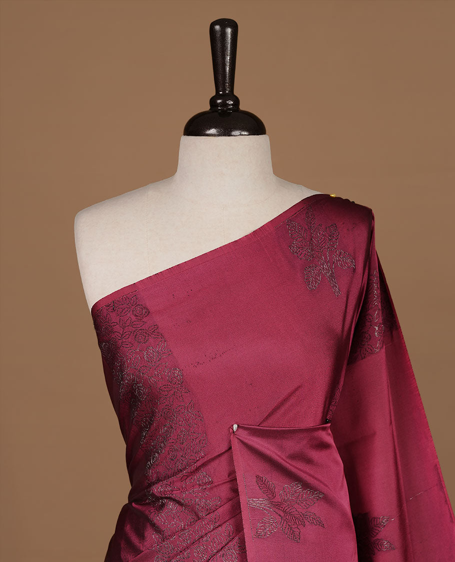 Dusty magenta soft silk saree features a sleek borderless design with intricate antique zari motifs, flowing into a seamless self colored pallu and a matching blouse piece.