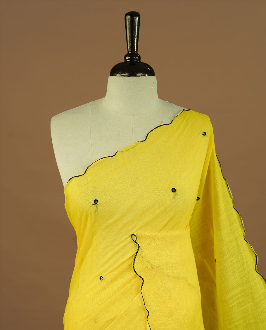 Yellow colour Semi Linen saree featuring mirror work with intricate thread detailing, enhanced by a stylish scallop border. Comes without a blouse piece.