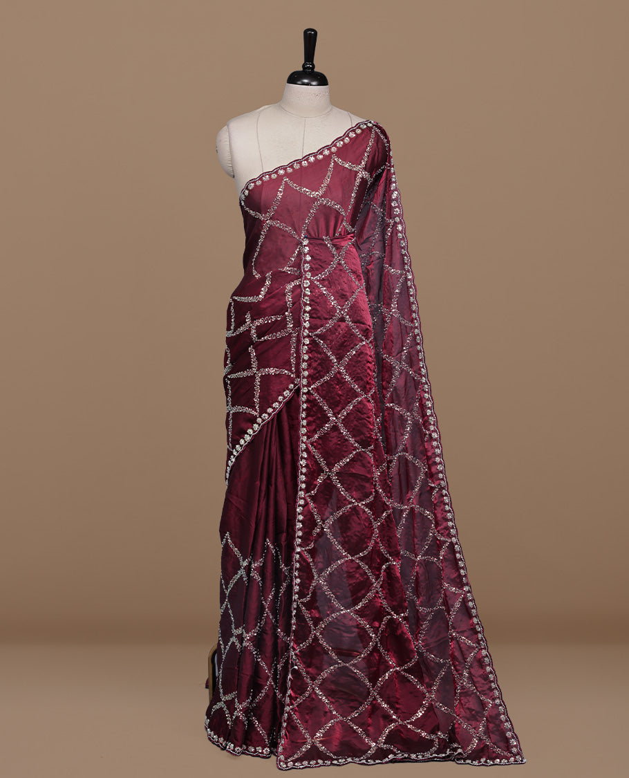Maroon colour designer saree featuring Sequins & cut beats worked body, cut beat worked border, paired with matching unstitched blouse.