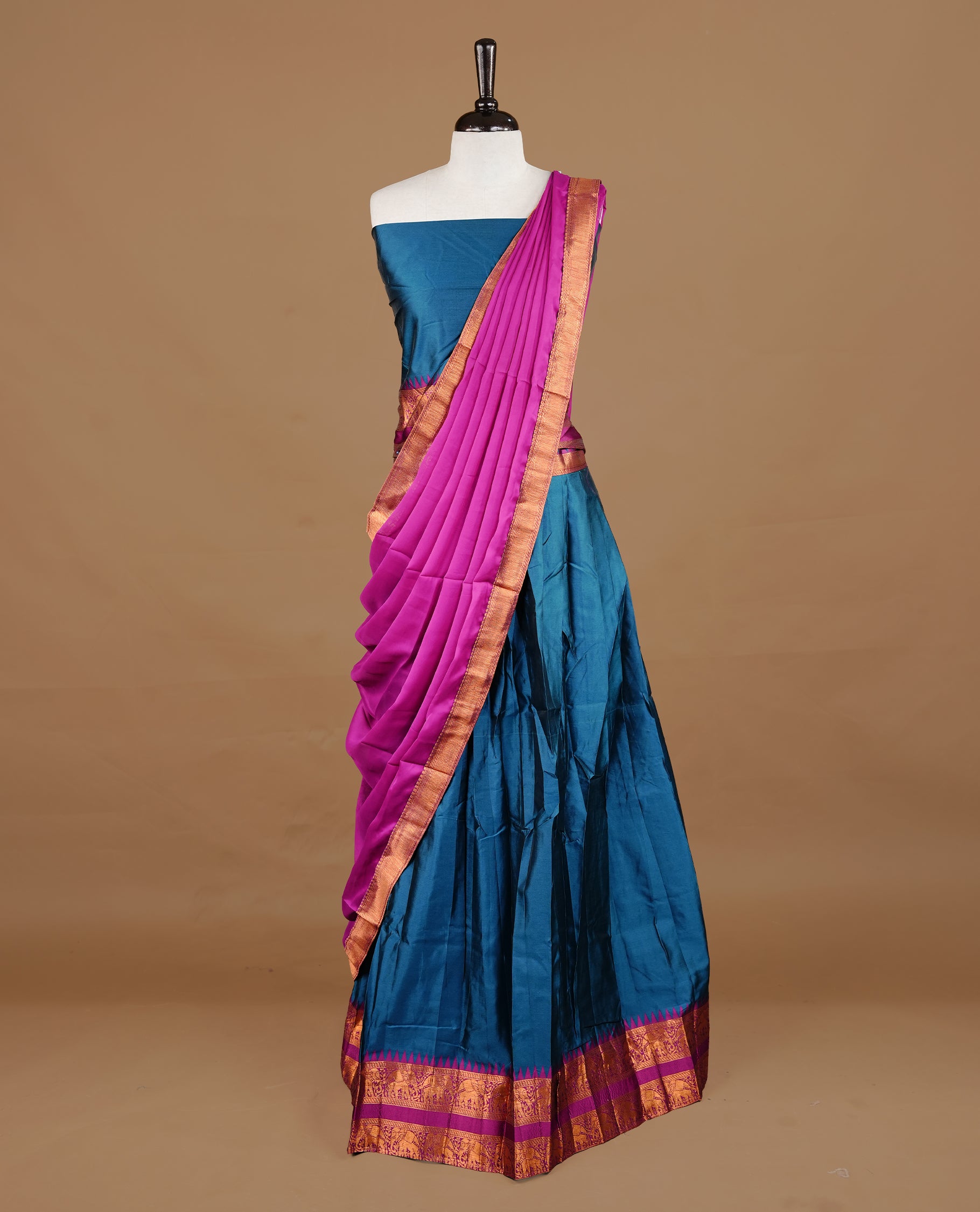 Teal colour semi stitched Half saree featuring contrast Magenta colour with gold zari traditional border skirt, paired with matching zari border dupatta, unstitched blouse piece