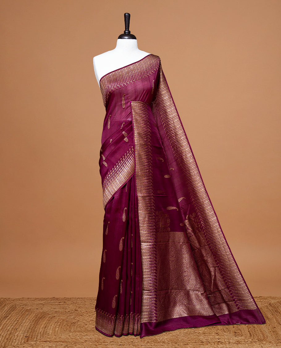Deep Mauve colour Semi Banaras Tussar Georgette Featuring Gold zari Leaf pattern on body, Finished with Gold zari border and paired with matching blouse piece.