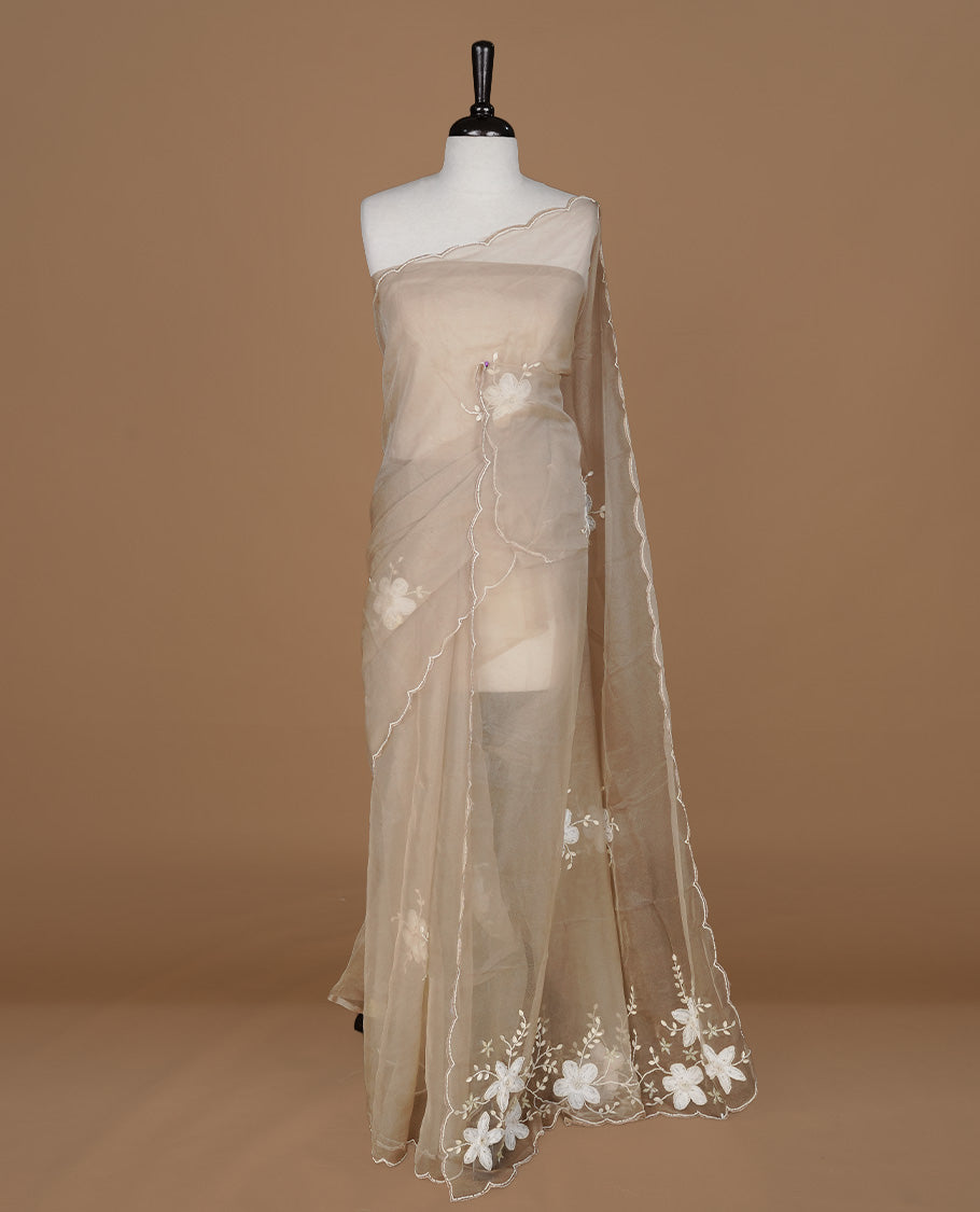 Light coffee colour crush organza saree featuring white floral work with beats & sequins, highlighting scalp with beats worked border, paired with matching blouse piece.