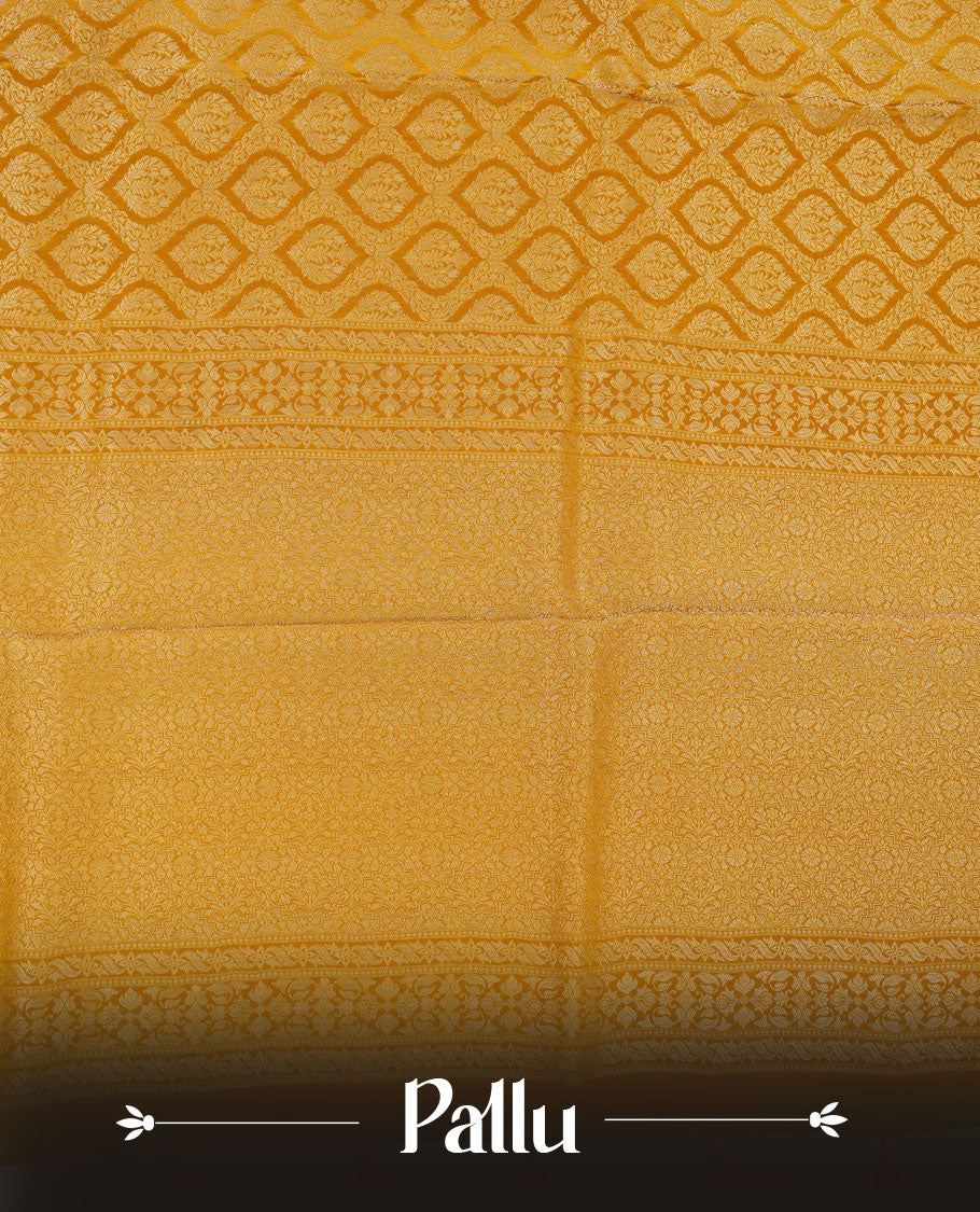 Yellow colour banaras satin crepe saree featuring gold zari pattern across body, with self colour border with gold zari pattern and paired with matching blouse.