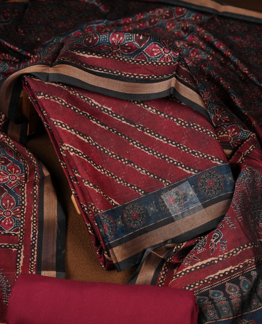 Maroon colour churidar material featuring a striped printed body, paired with an intricately printed dupatta and a matching solid bottom.