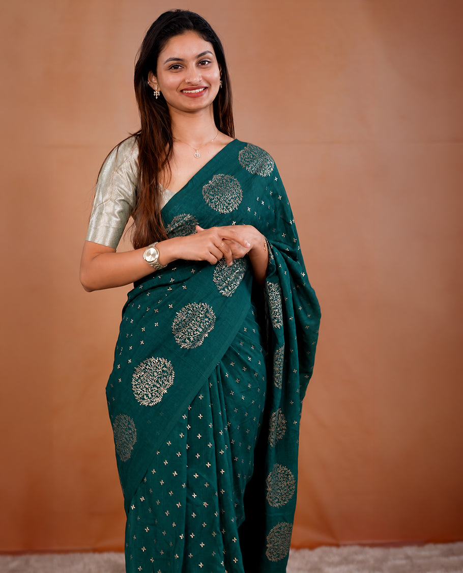 Teal Green colour vijithra silk saree featuring small zari details on body, Tree design border.