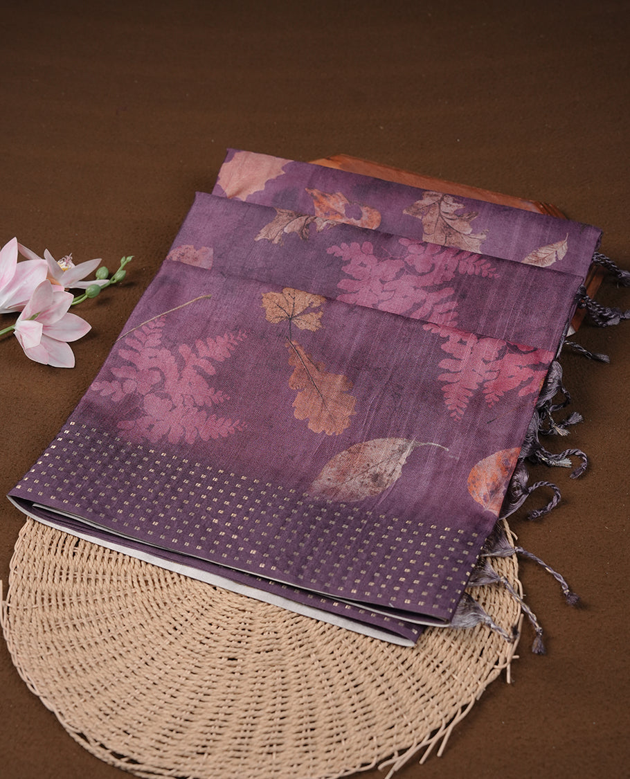 Grape colour tussar saree featuring woven Eco leaves printed on the body, complemented by a self colour gold zari bindi butta border & pallu, paired with a matching blouse.