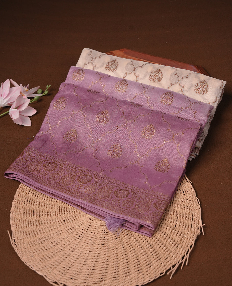 Cream colour semi tussar Banarasi saree featuring Antique zari motifs on body, paired by contrast onion pink colour border, and a matching blouse piece.