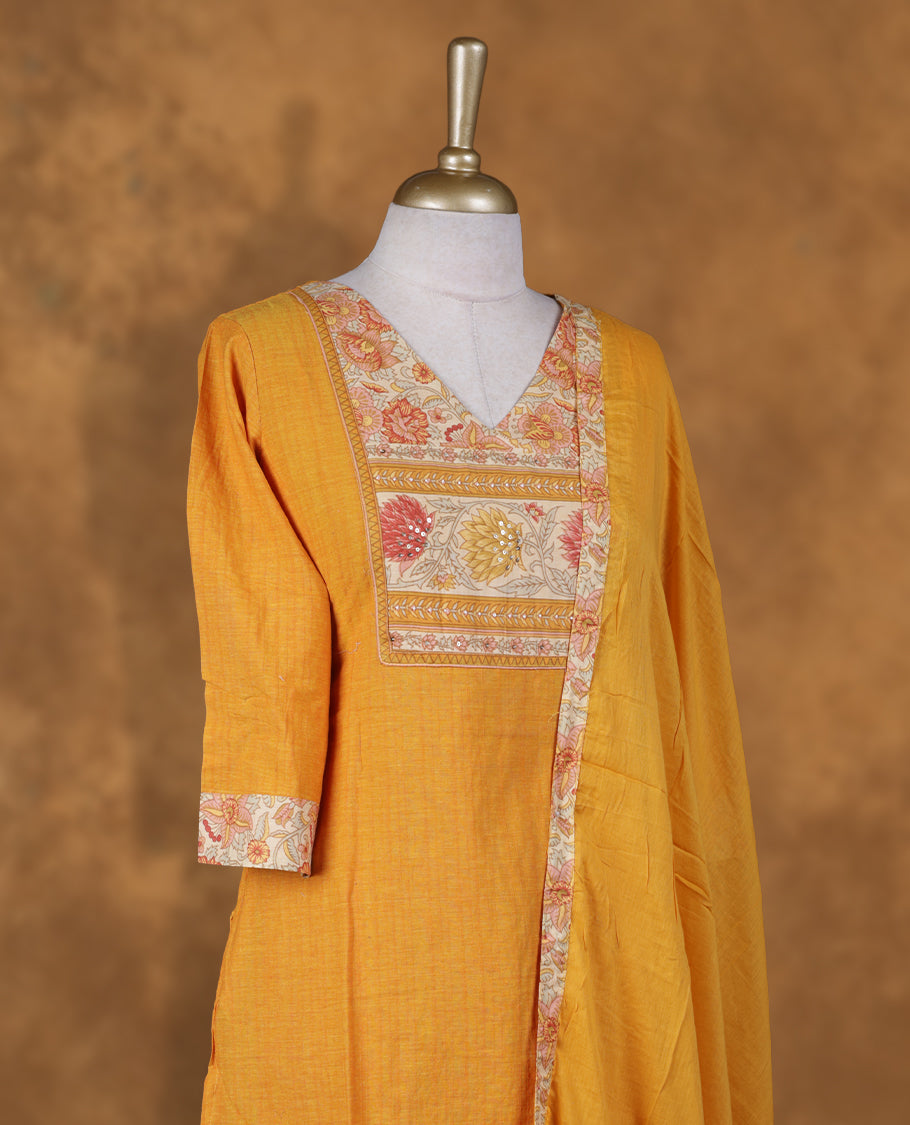 Yellow colour churidar set featuring tiny stone on V neckline, sleeves, and plain the body, Paired with a matching dupatta