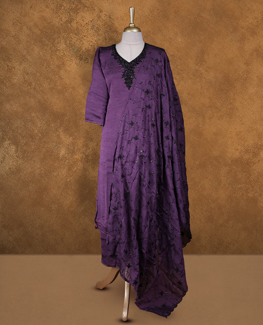 Purple colour churidar set featuring V neckline, three‑fourth sleeves, and tonal bead and thread embellishment along neckline and body, paired with a matching embroidered dupatta.