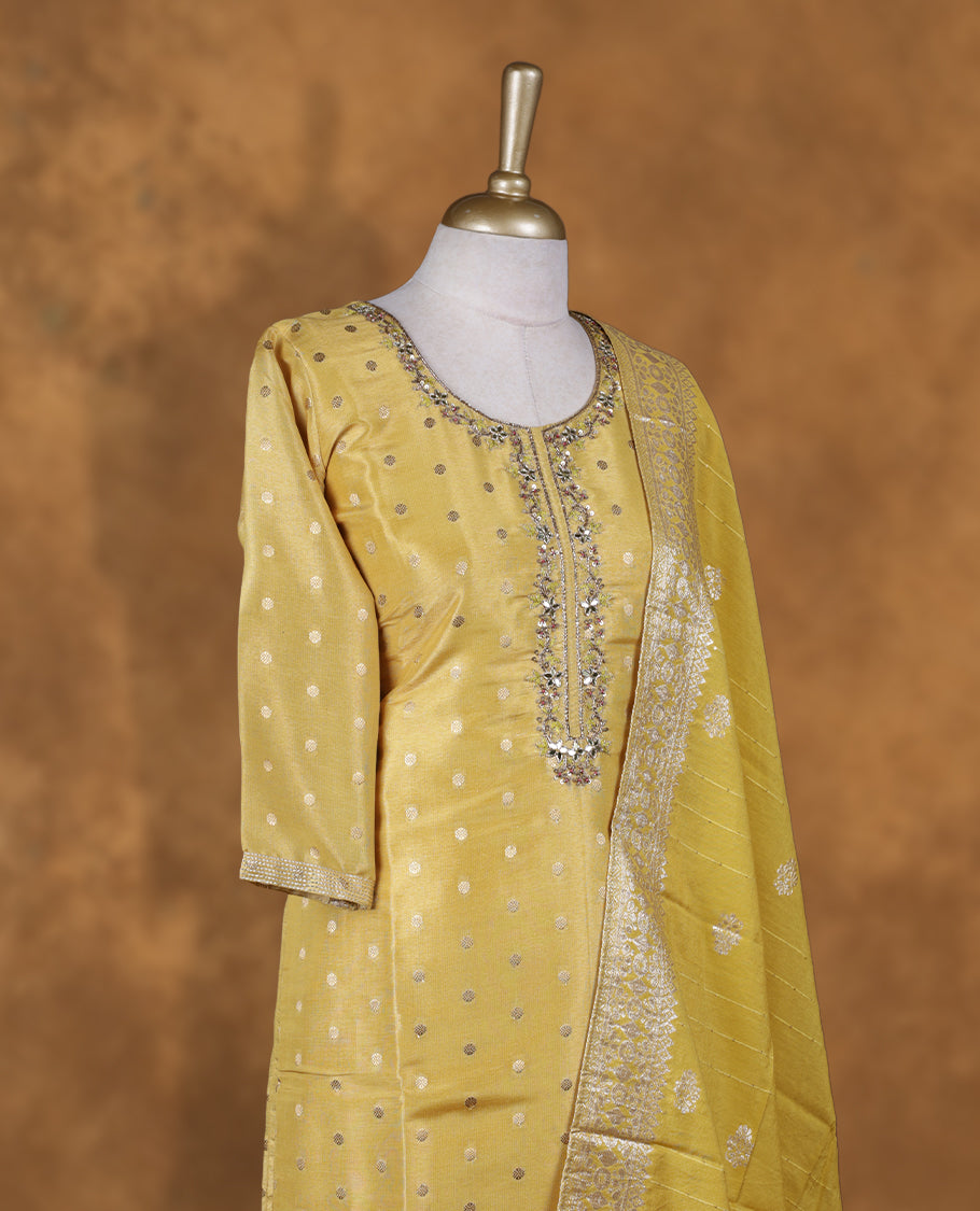 Yellow colour churidar set featuring thread and cut beats embroidered neckline, sleeves, and Gold colour motifs on body , Paired with a matching dupatta