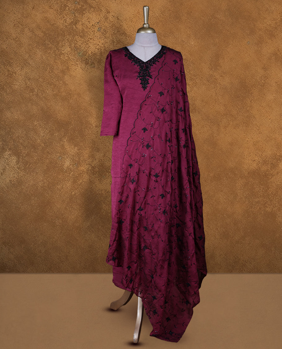 Wine purple colour churidar set featuring V neckline, three‑fourth sleeves, and black bead and thread embellishment along neckline and body, paired with a matching embroidered dupatta.