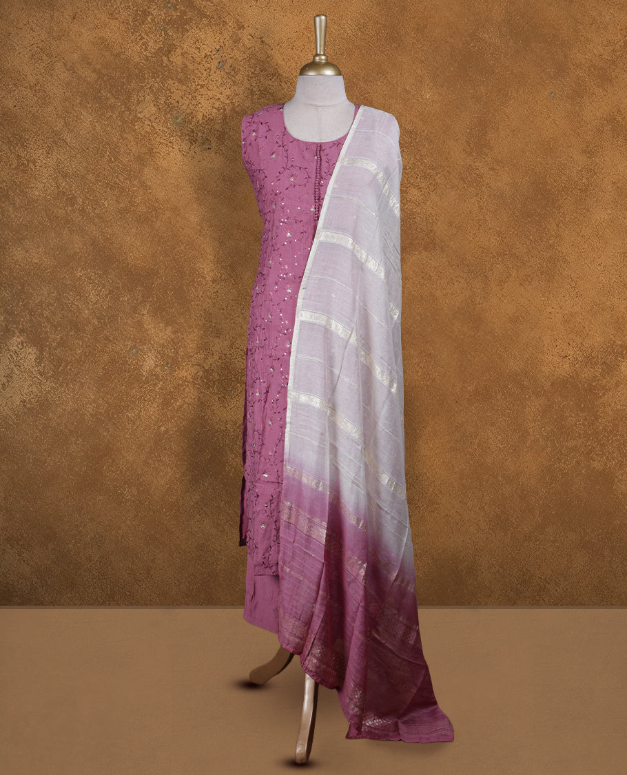 Dusty mauve colour churidar set featuring round neckline, sleeveless pattern, and delicate tonal thread and sequin embroidery on body, paired with a soft white and mauve dip‑dyed striped dupatta.
