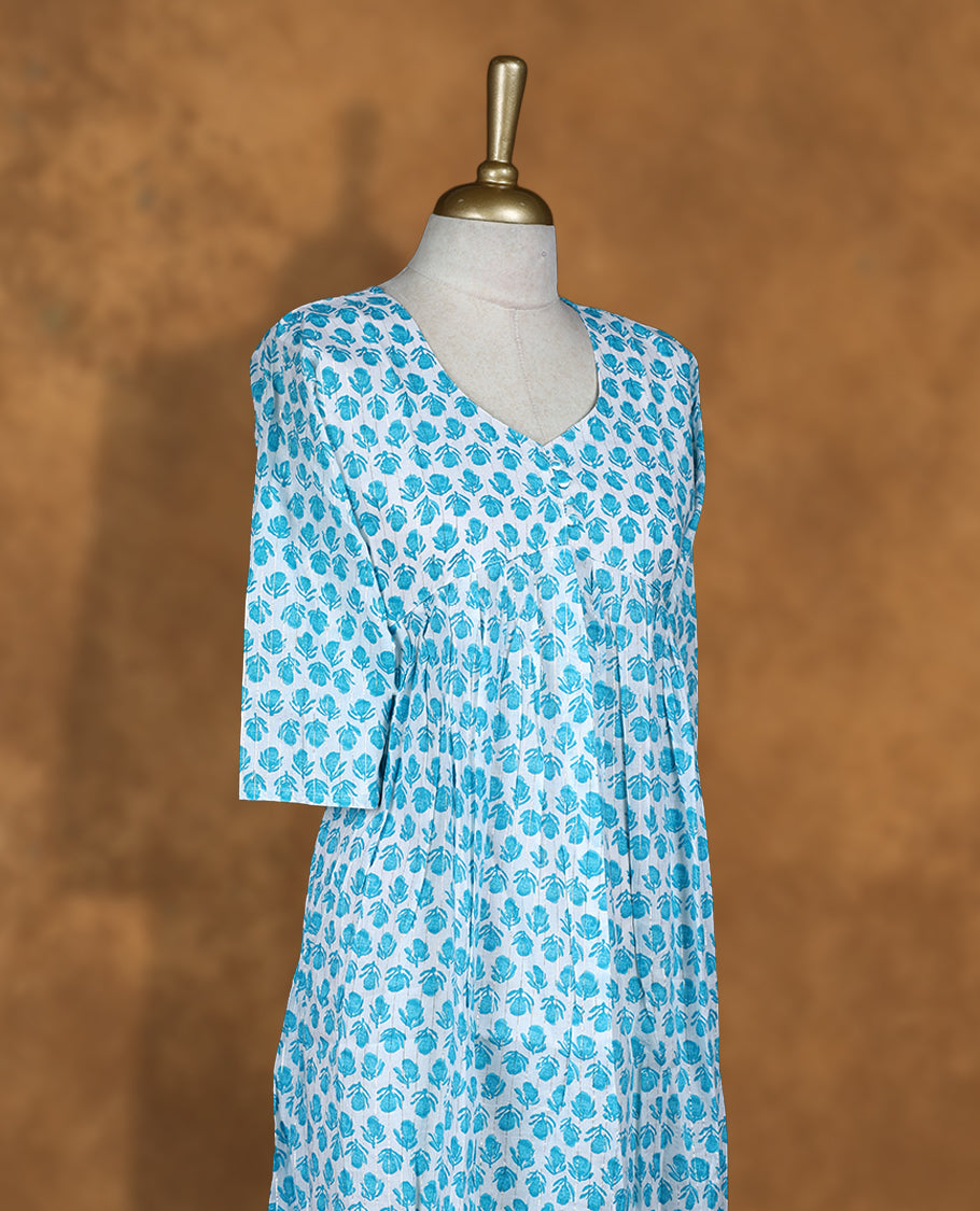 White colour Kurti featuring Blue floral print pattern across, round neckline with botton detail, and sleeves,