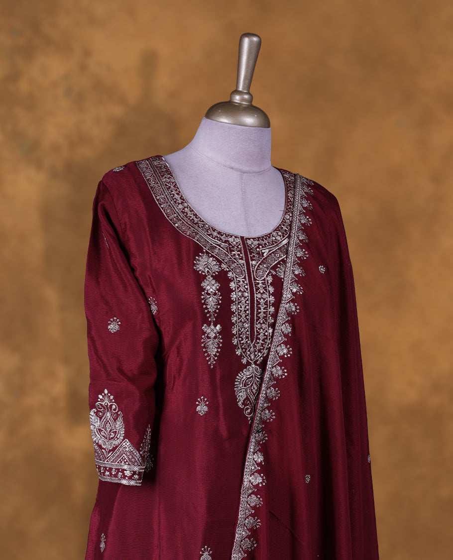 Dark red colour sharara set featuring gold colour thread and beats embroidered neckline, sleeves, and thread embroidery on body , Paired with a matching dupatta