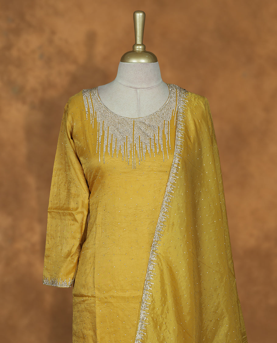 Yellow colour sharara set featuring gold colour stone worked on neckline, sleeves, and Stone scattered on body , Paired with a matching dupatta