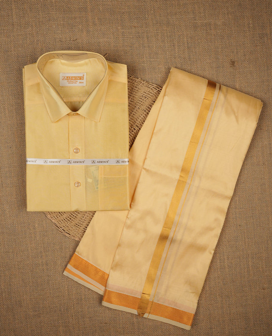 Champ colour shirt and dhoti with gold colour border, paired with matching colour silk saree featuring gold zari buttas and traditional border paired with matching blouse piece.