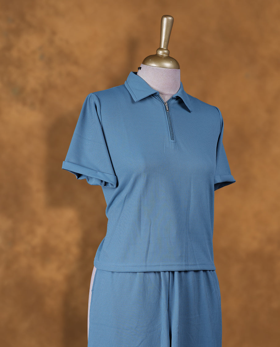 Teal colour coord set styled with a T shirt design with zip detailed & collar , short sleeve, pair a matching bottom pant .