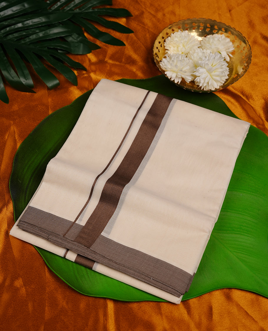 Cream colour double dhoti featuring brown colour zari border