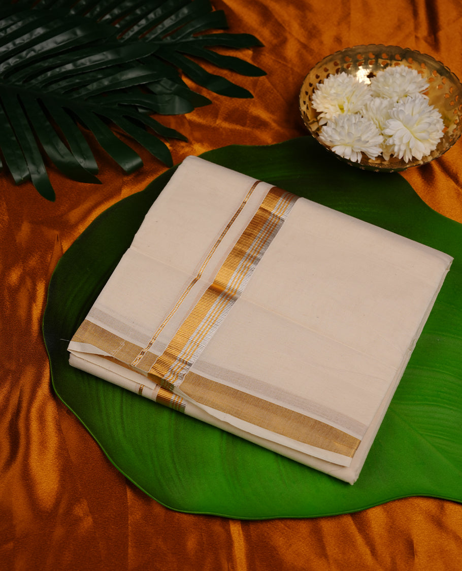 Cream colour cotton double dhoti featuring 2 inch gold and silver kasavu zari border