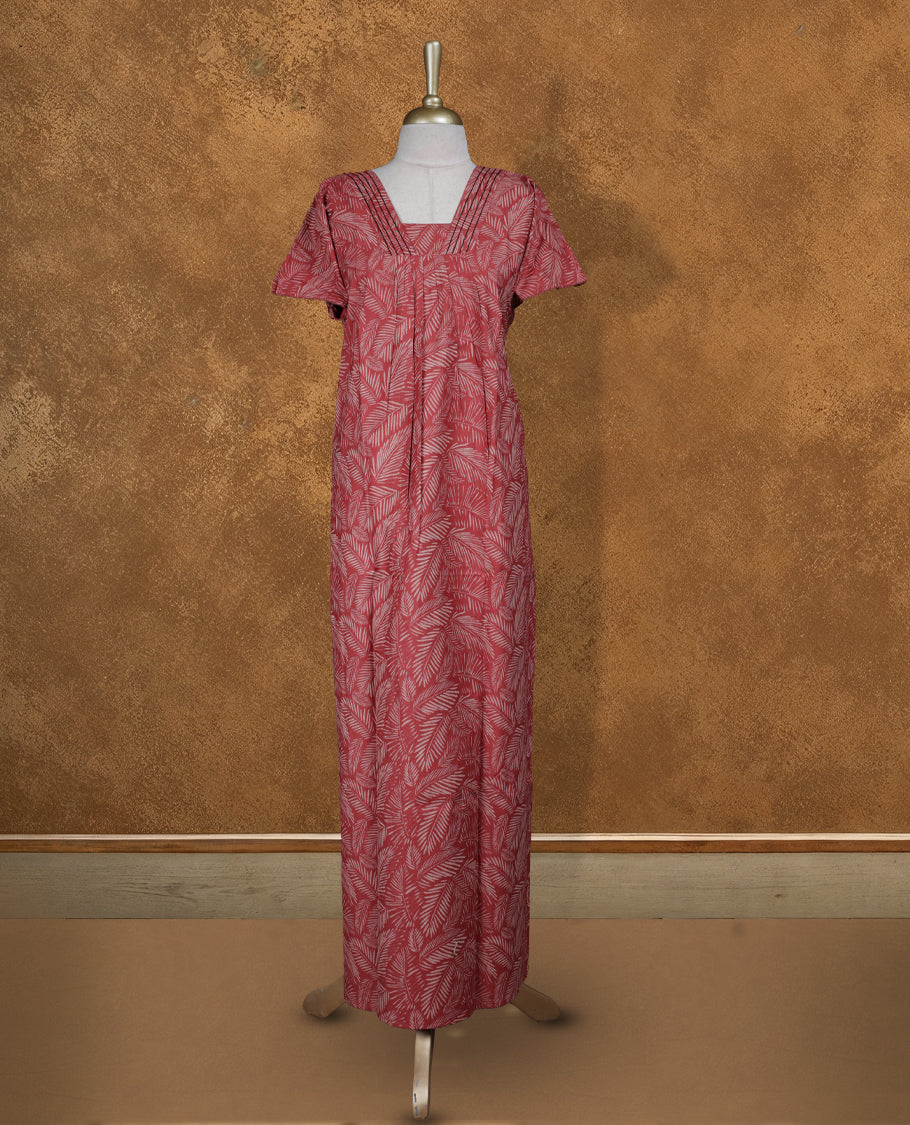 Red colour NStyle nighty featuring cream leaf patterns, a V-neckline with thread detailing, short sleeves, and a full ankle-length design