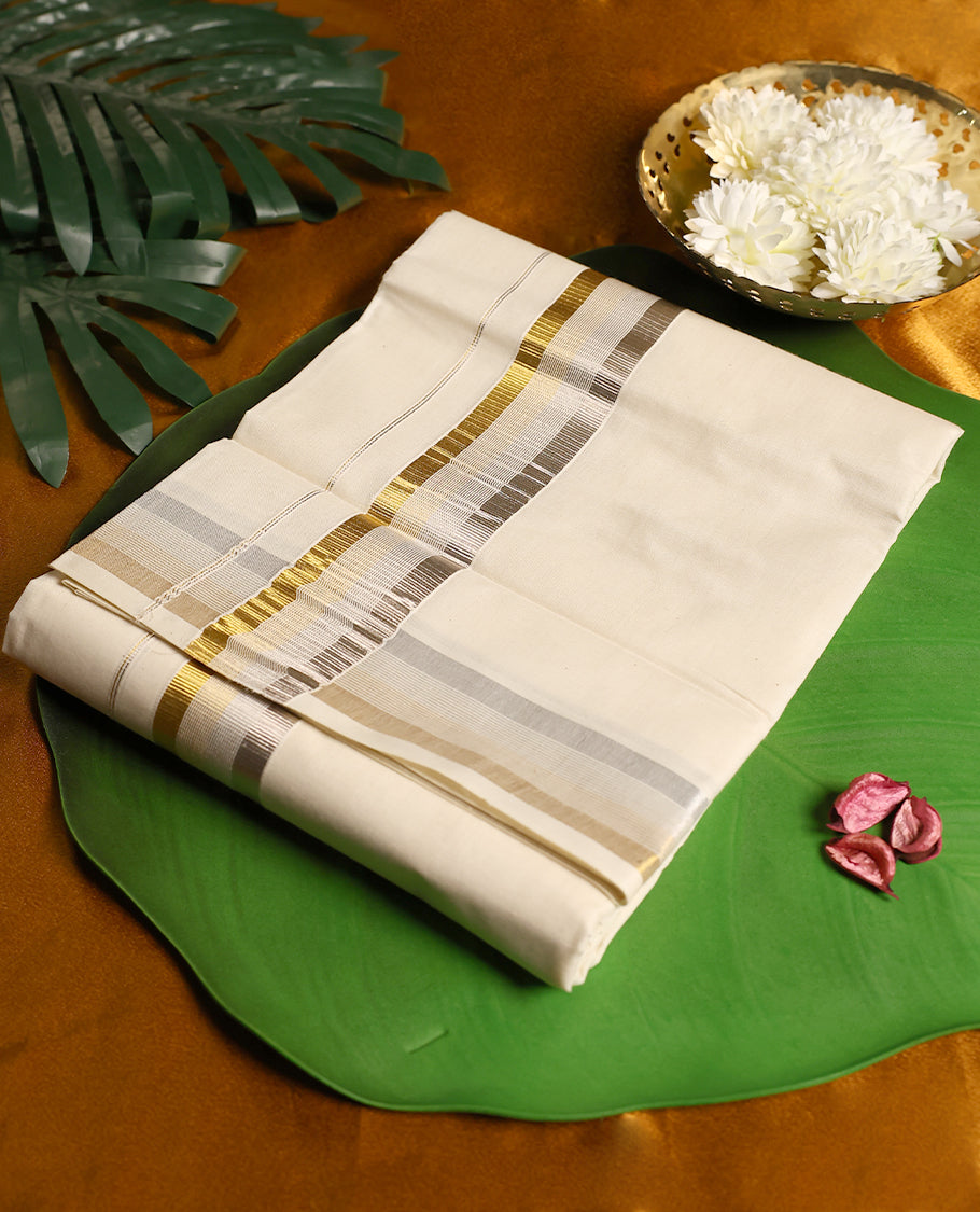 Off white colour cotton double dhoti adorned with a dual tone border in silver and gold zari, highlighted with fine stripe detailing, offering a graceful and festive traditional look perfect for cultural occasions.