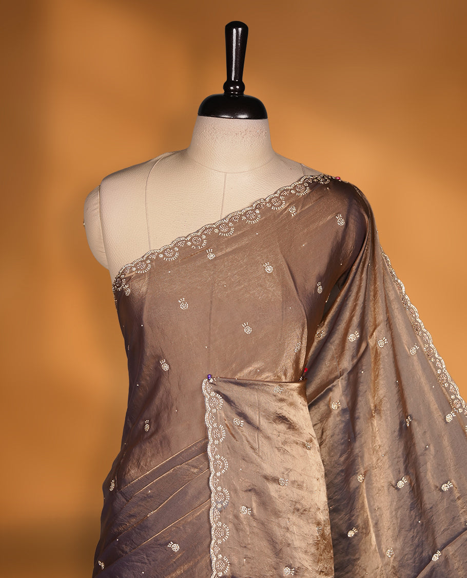 Antique Gold Colour Chiffon Designer Saree featuring Delicate White Stone Work All Over the Body, with Stone Detailing on the Border and Pallu, paired with a Matching Blouse.