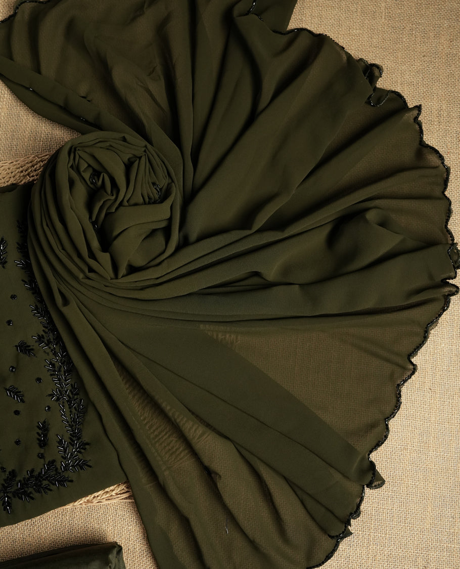 Dark Olive green colour suit material adorned with intricate black cut beads work, exuding sophisticated charm & paired with a soft dupatta and a matching plain bottom.