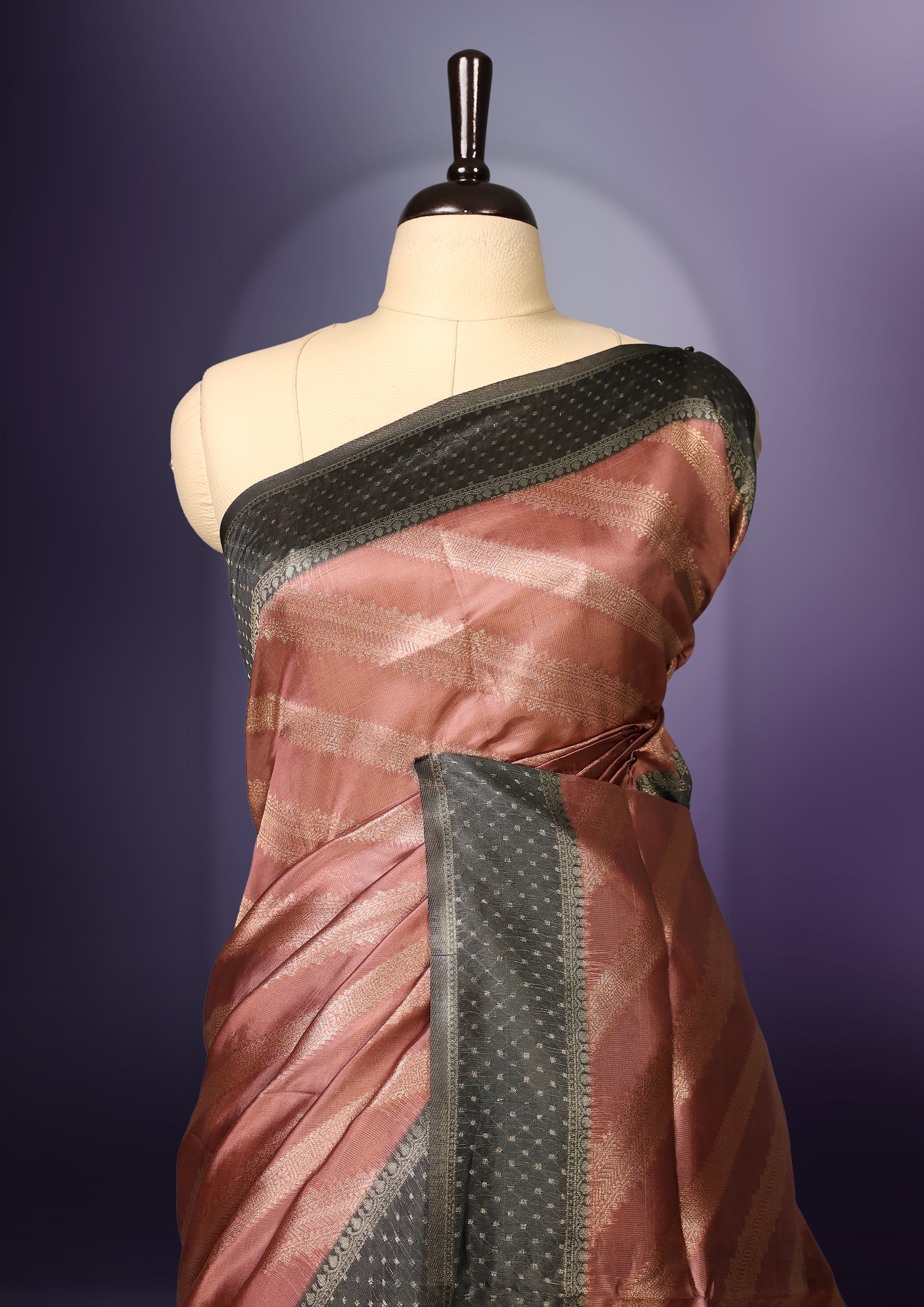 Golden Peach colour saree featuring subtle self striped woven patterns on the body, enhanced with a olive green geometric border, complemented by a rich zari pallu with tassels, and paired with a matching blouse for a traditional elegant look.