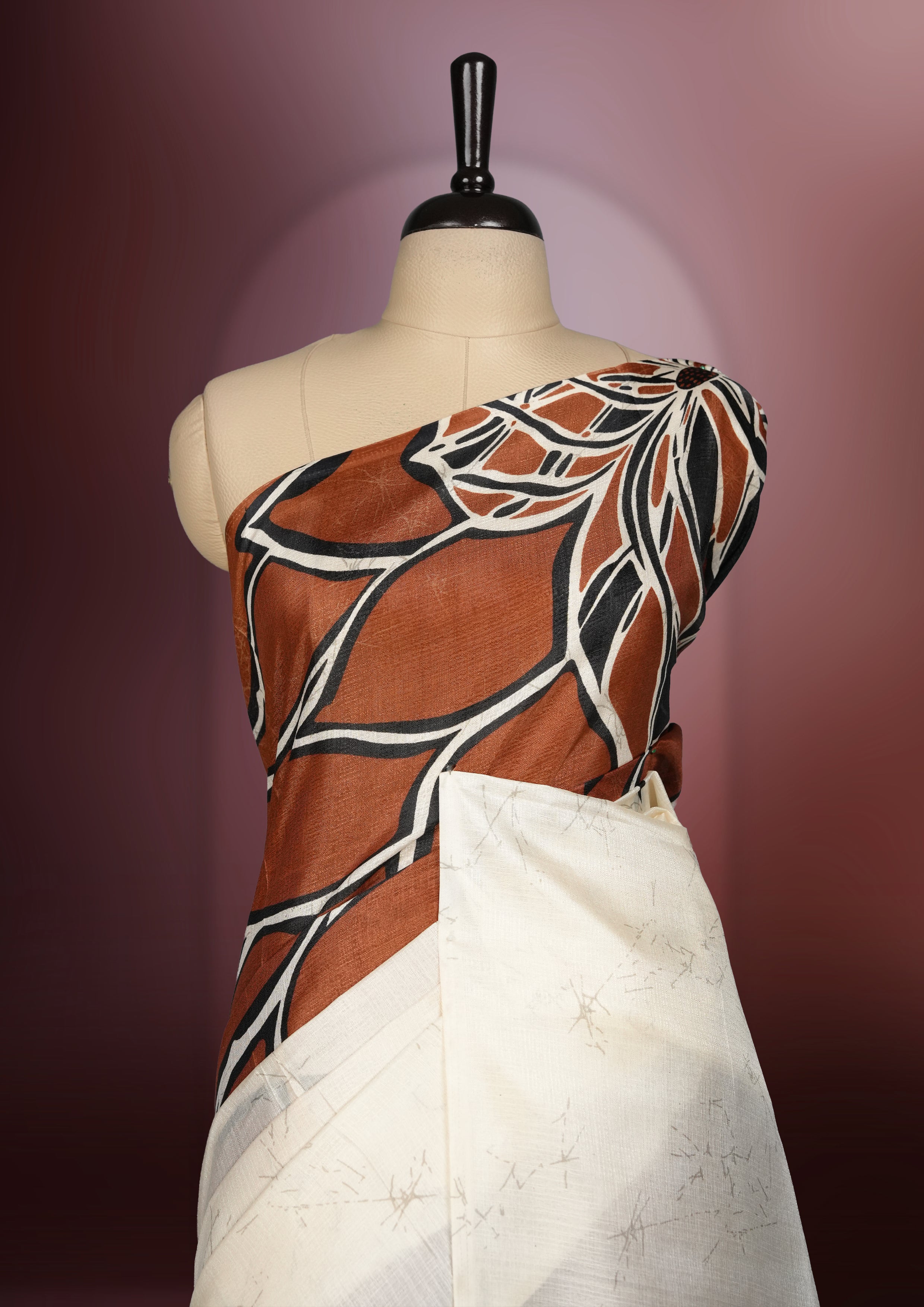 Brown and off white colour saree featuring bold abstract floral patterns, blending contemporary black colour design with ethnic elegance & paired with a matching blouse.