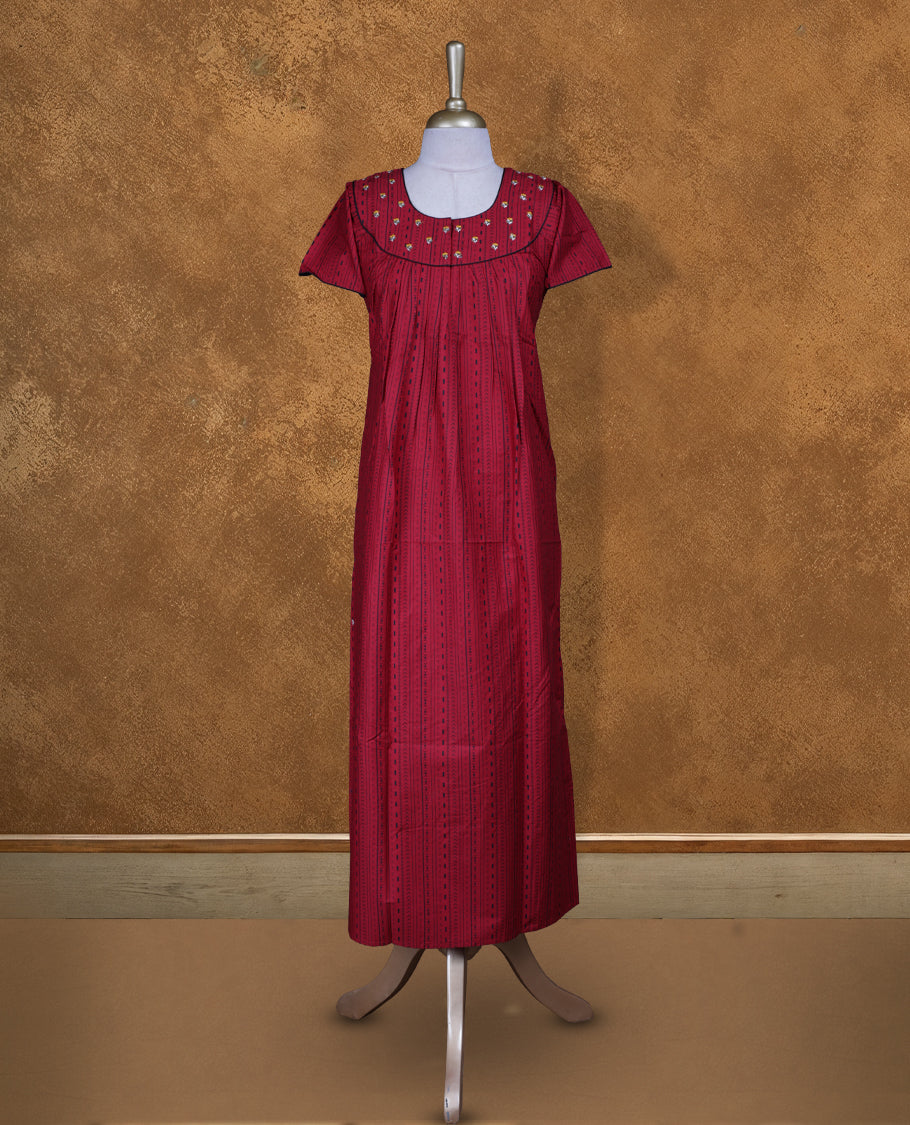 Dark red colour Nstyle nighty with featuring a White floral and black pattern, a V neckline with black lace Border, Short sleeve, and a full-length