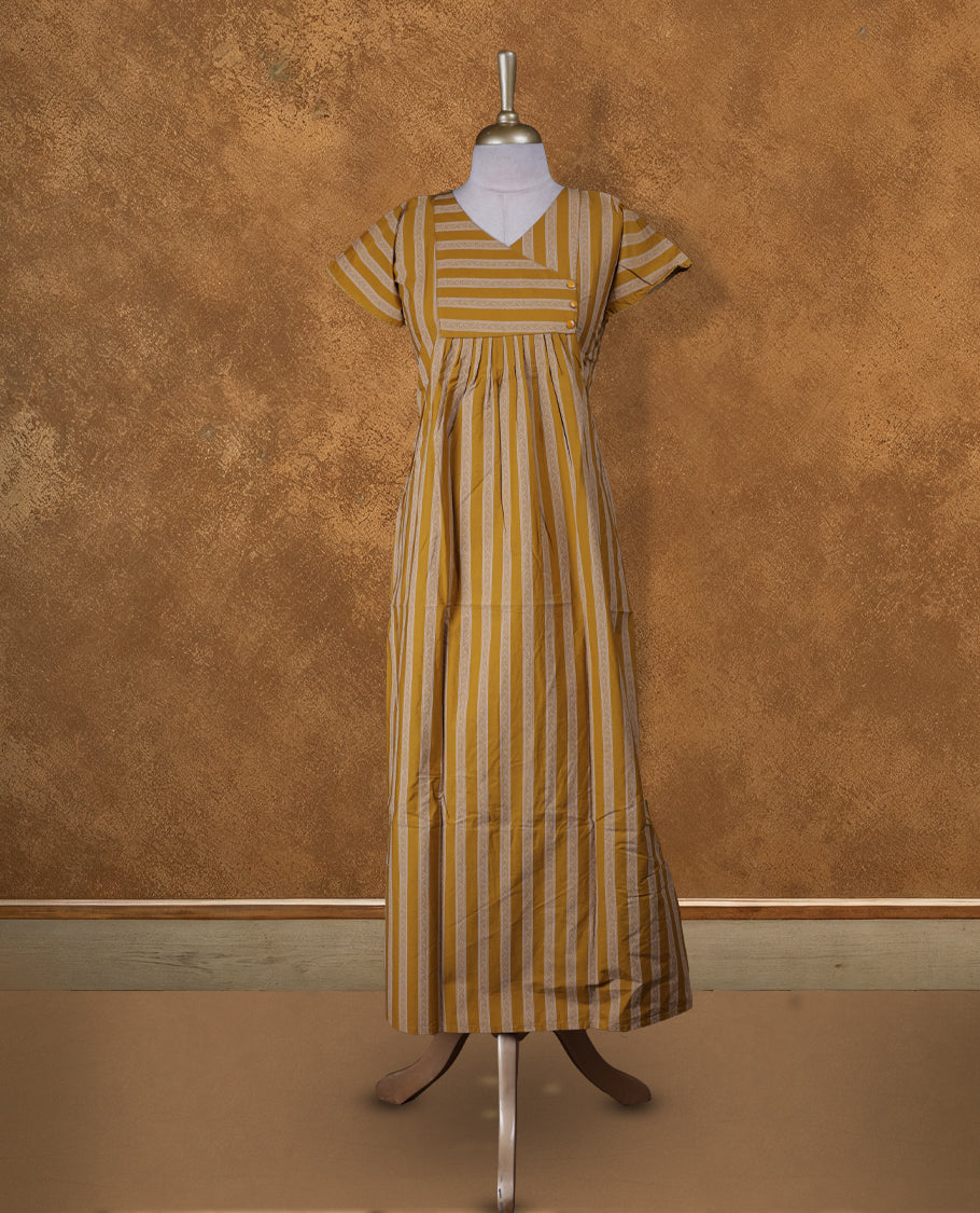 yellowish gold colour NStyle nighty featuring coloured leaf patterns, a V-neckline, short sleeves, and a full ankle-length design.