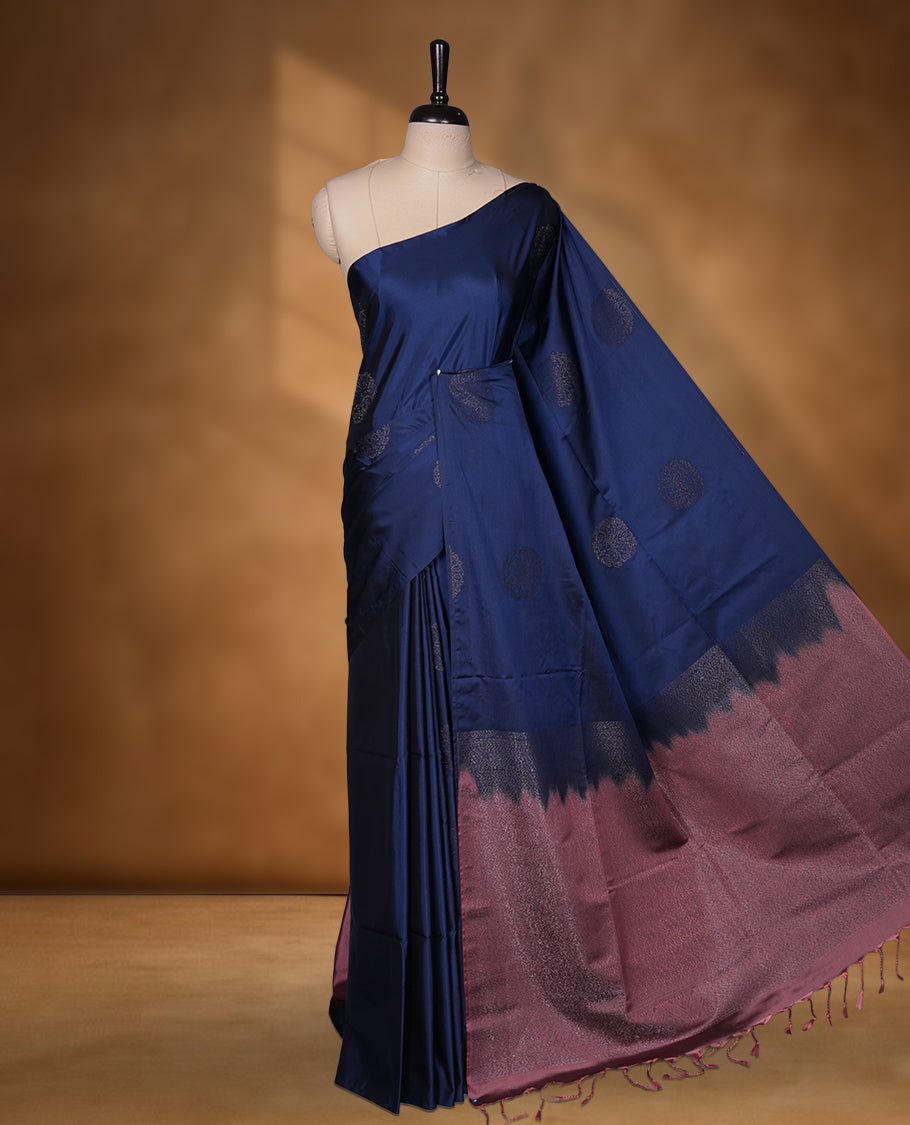 Navy blue colour soft silk saree featuring Antique zari motifs on body with Highlighting contrast Pink colour pallu and paired with matching blouse piece.