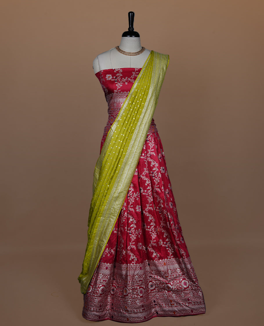 Red colour semi banaras semi stitched dhavani set featuring gold zari floral kodi motifs and traditional border, unstitched matching blouse piece and contrast Olive colour Duptta with silver zari border border.