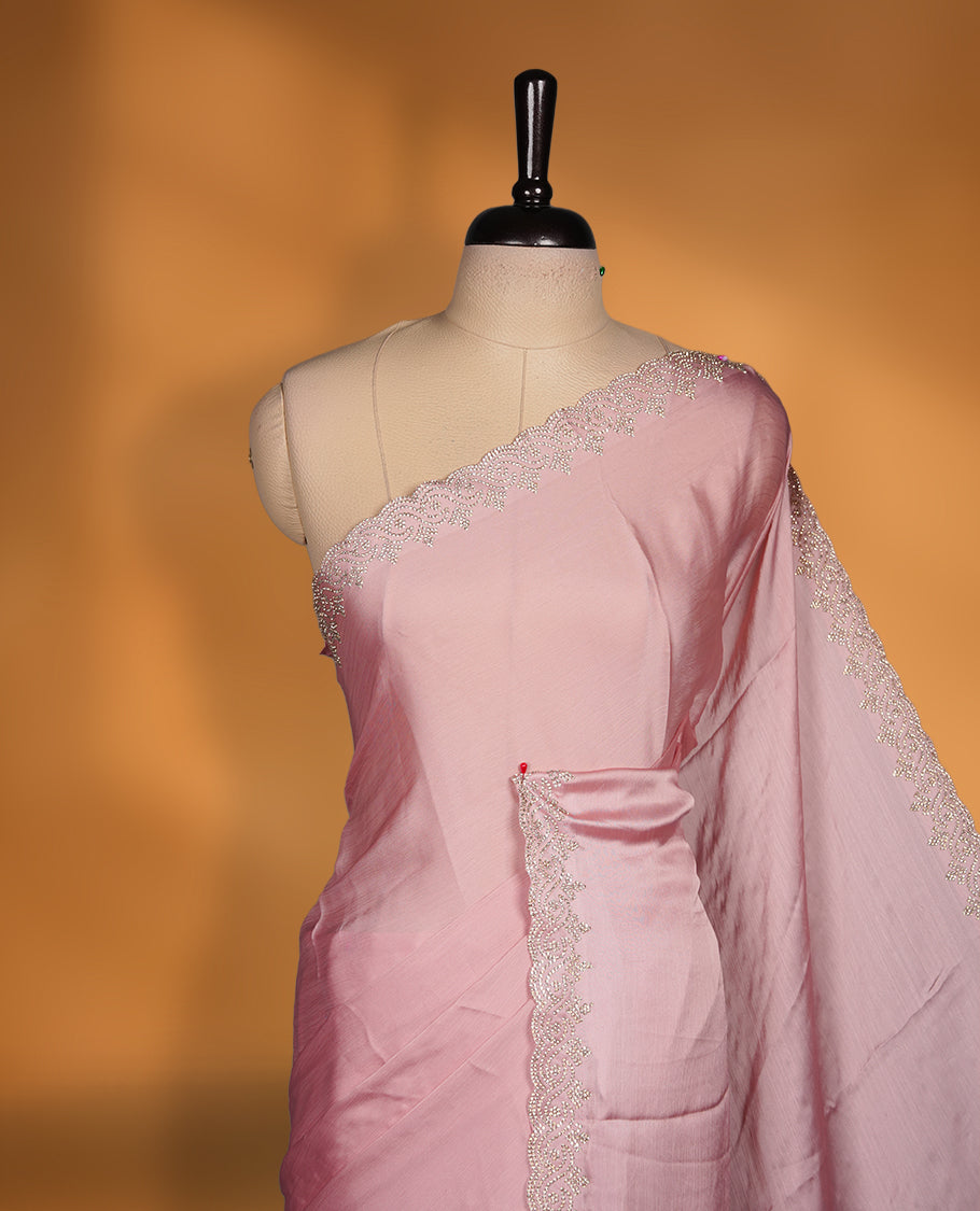 Light Pink colour chiffon designer saree featuring delicate silver stone embellishments along the border and pallu, paired with a matching embellished blouse.