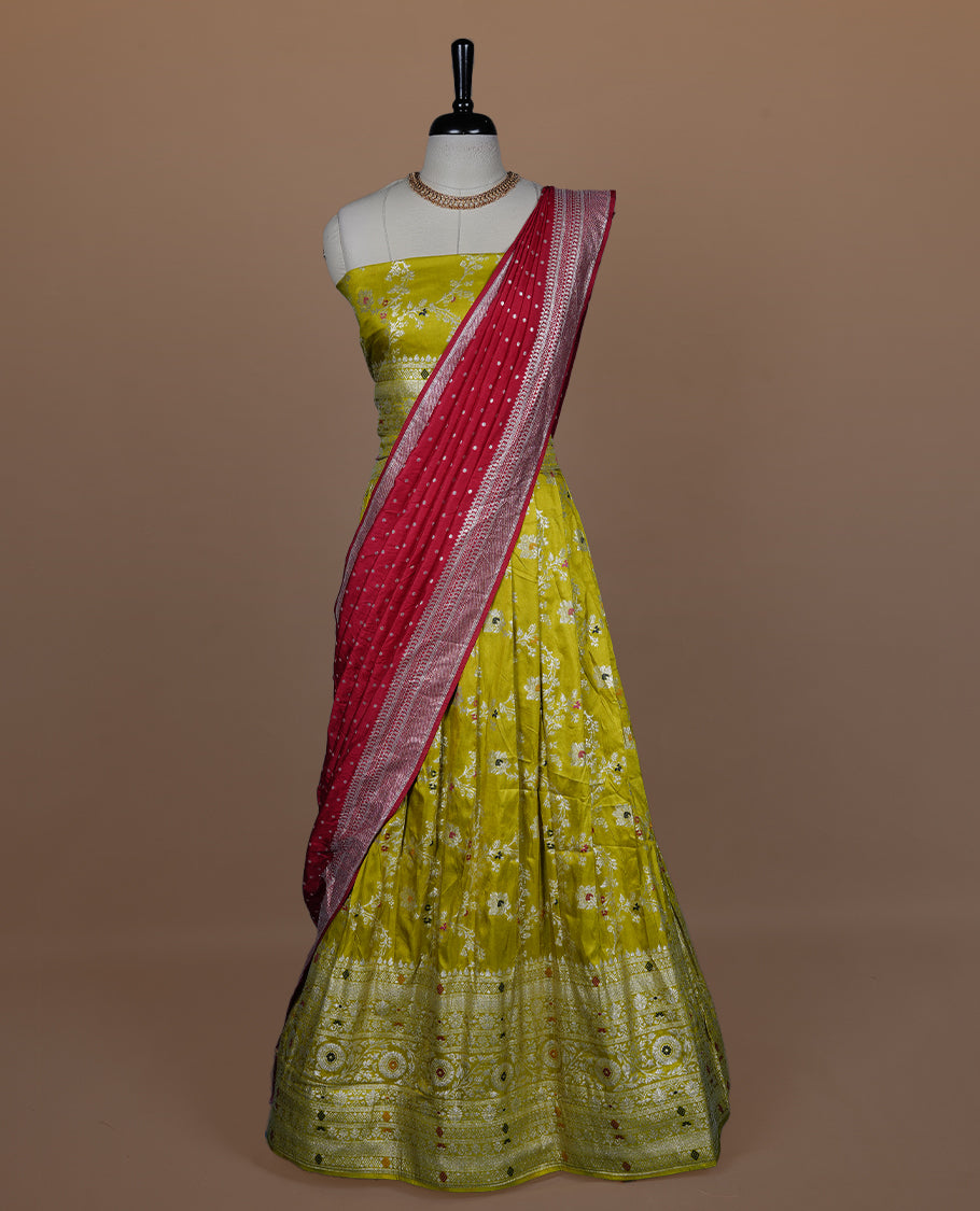 Olive colour semi banaras semi stitched dhavani set featuring silver & multicolour zari motifs and traditional border, unstitched matching blouse piece and contrast red colour Duptta with silver zari border.