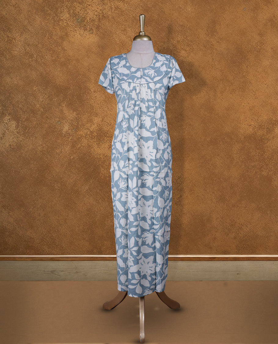 Aqua Blue colour NStyle nighty featuring white floral patterns, a round neckline with thread detailing, short sleeves, and a full ankle-length design.