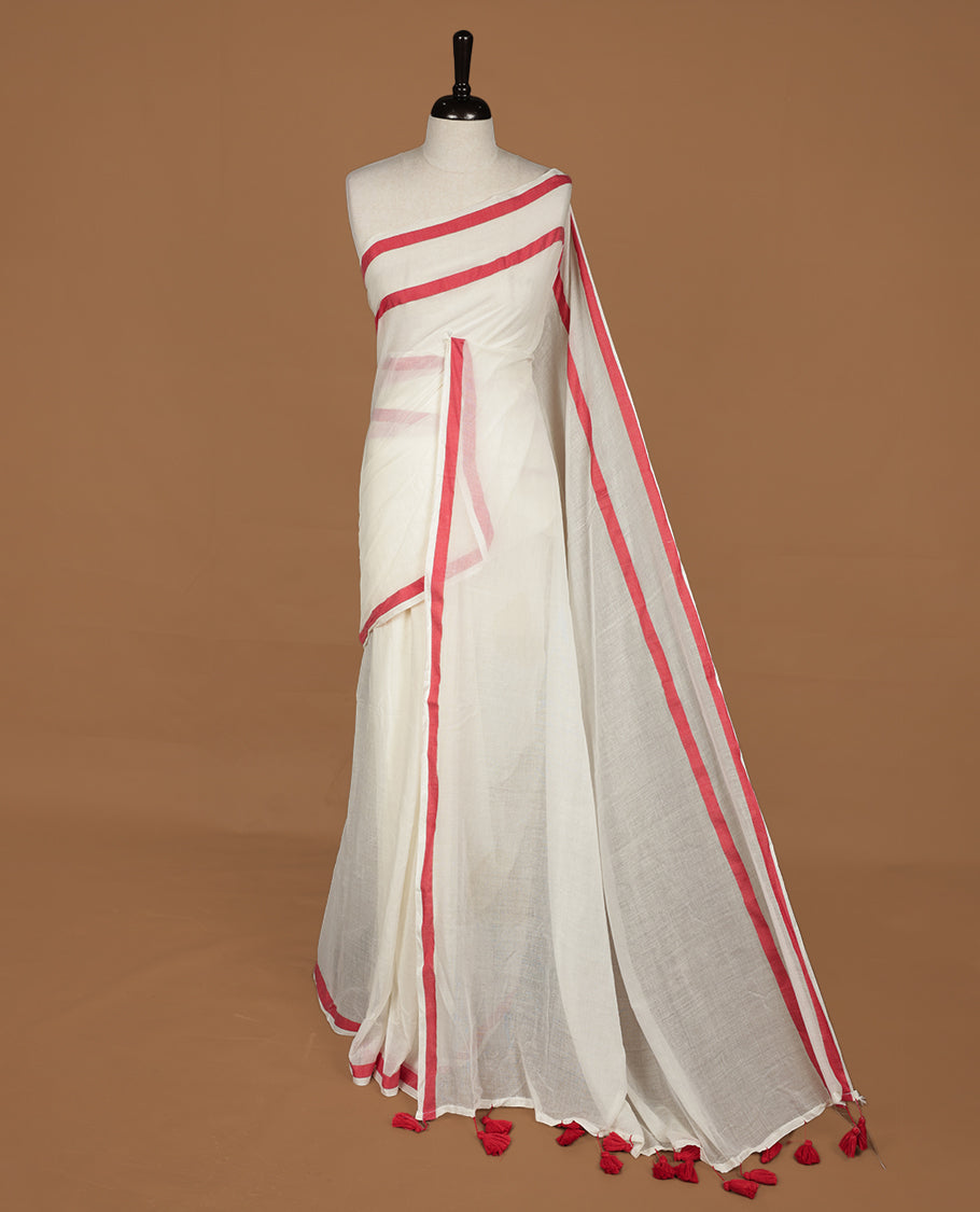 Off white saree with red tones, featuring a minimal plain design on the body, without blouse piece.