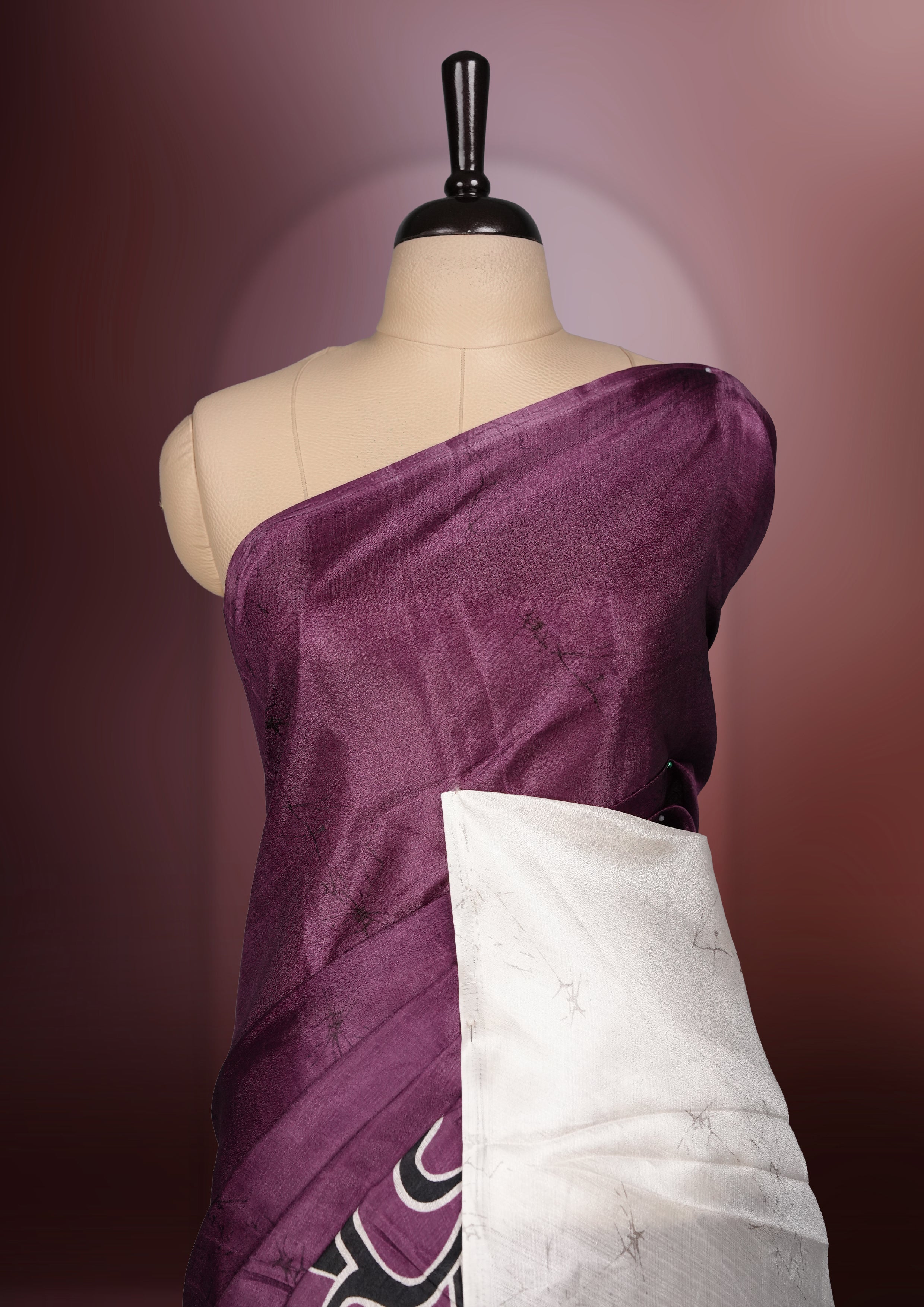 Dark onion pink colour saree adorned with bold off white floral prints, blending tradition with a modern twist & paired with a matching blouse.