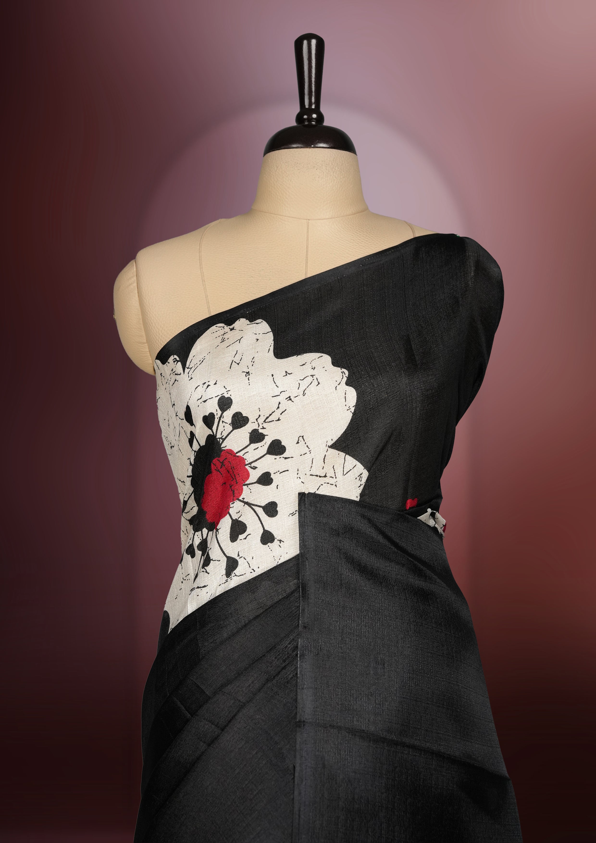 Black colour Semi khadi saree with bold white floral motifs and subtle red accents, exuding timeless elegance and modern charm, paired with a matching blouse.