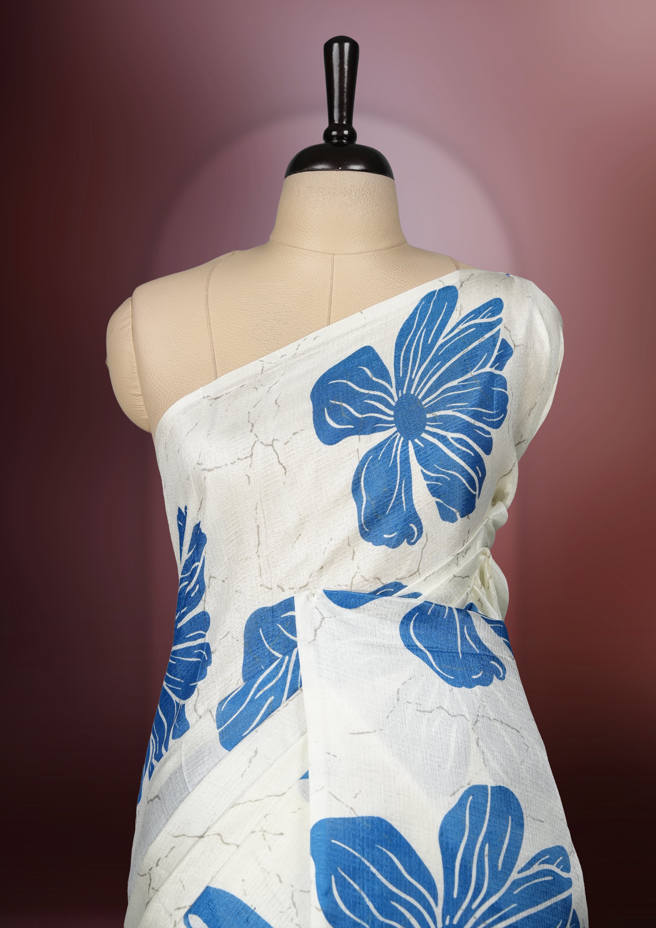 Sapphire blue colour semi khadi silk saree with off white floral motifs and subtle , exuding timeless elegance and modern charm & paired with a matching blouse.