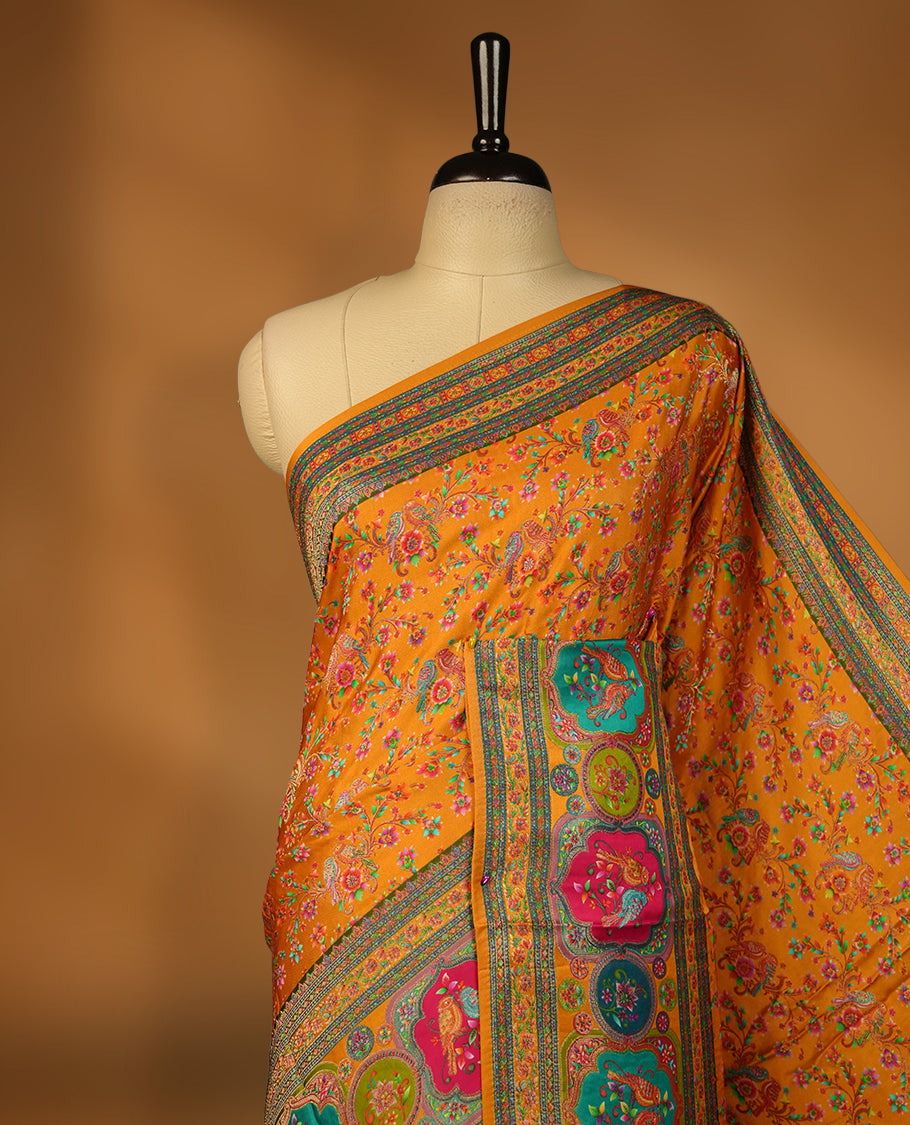 Orange colour Pashmina silk saree densely woven with intricate multicolour floral kodi pattern across the body, framed by an opulent arabesque border and grand storytelling pallu, paired with a matching woven border blouse piece