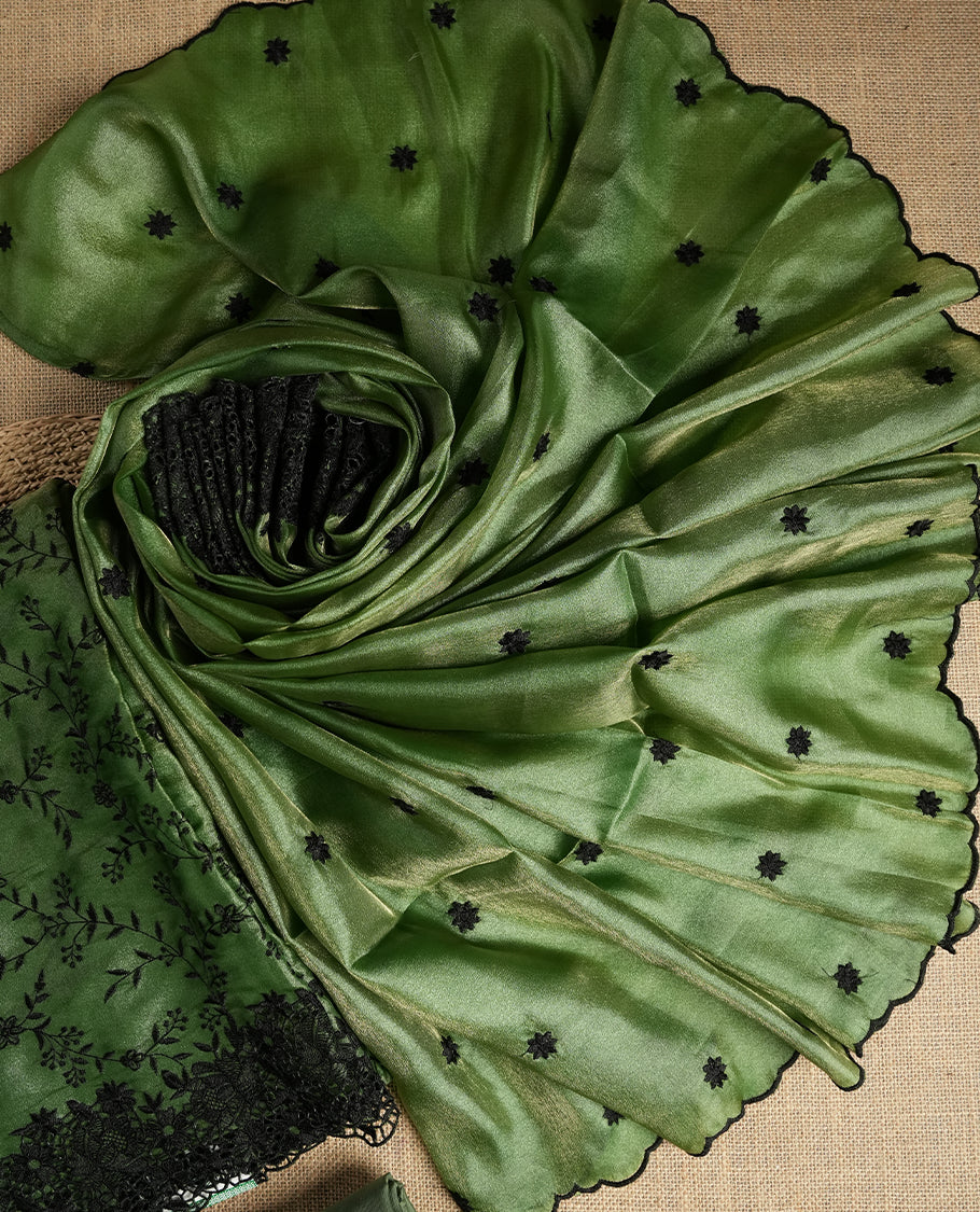 Rich Green colour dual shaded suit material with delicate black floral embroidery and lace border & Includes matching dupatta with embroidered motifs and plain bottom fabric.
