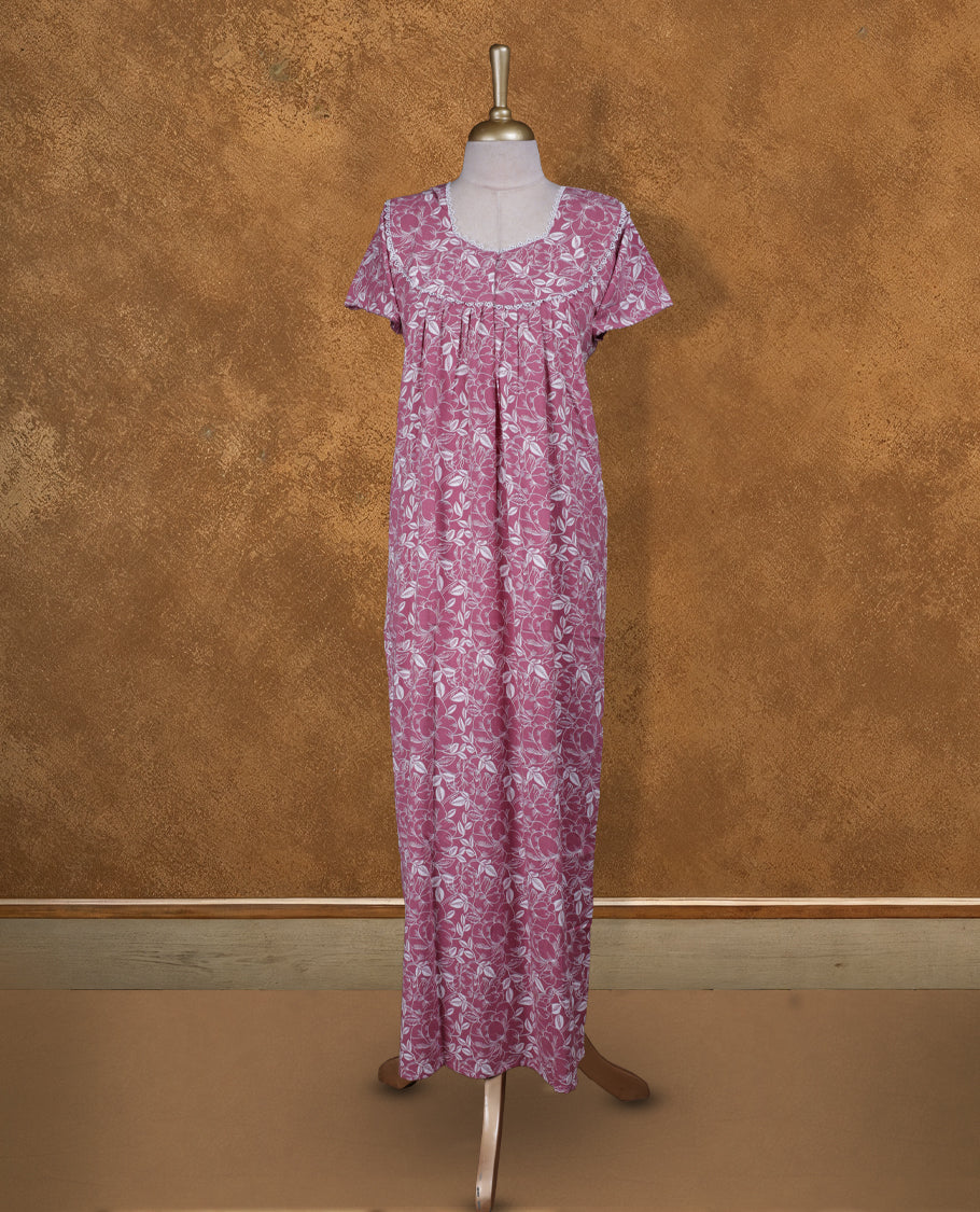 Pink colour NStyle nighty featuring white floral patterns, a round neckline with lace trim detailing, short sleeves, and a full ankle-length design.