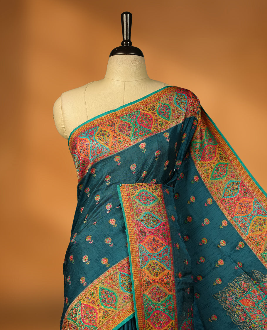Crystal Teal colour Pashmina silk saree densely woven with intricate multicolour floral and architectural motifs across the body, framed by an opulent arabesque border and grand storytelling pallu, paired with a matching black woven border blouse piece