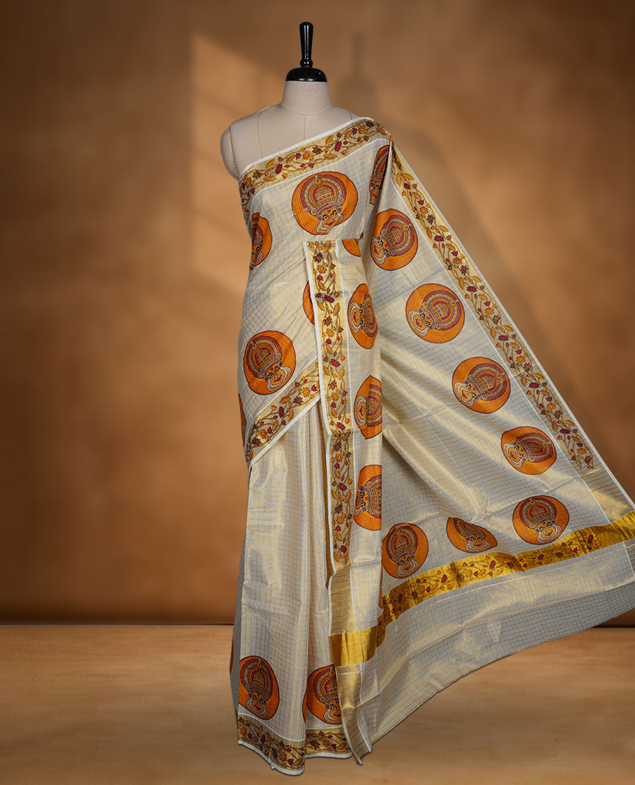 Light gold colour Tissue Kerala saree featuring a gold zari check pattern body, an intricately woven gold traditional border with floral and Indian art form print paired with a matching blouse.