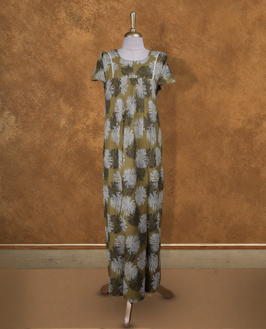 Mustard green colour Nstyle nighty with featuring a White and black leaf pattern, a round neckline with lace detailing, Short sleeve, and a full-length