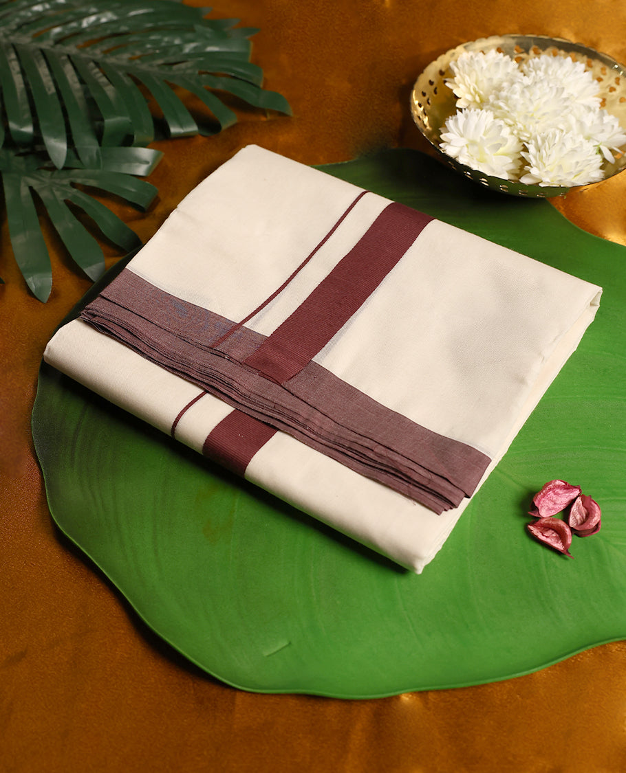 Off white cotton double dhoti enhanced with a deep maroon border and fine stripe detailing, offering a simple yet elegant traditional look perfect for daily wear, rituals, and cultural occasions.